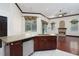Open kitchen features granite countertops, stainless steel appliances, and views to the living room fireplace at 140 Seville Chase Dr, Winter Springs, FL 32708
