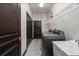 Modern laundry room with stainless steel washer and dryer, utility sink, and plenty of storage at 140 Seville Chase Dr, Winter Springs, FL 32708