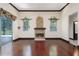 Living room showcases a stone fireplace, hardwood floors, and sliding glass doors to the outdoor patio at 140 Seville Chase Dr, Winter Springs, FL 32708