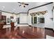 Spacious living area featuring hardwood floors and views of the kitchen at 140 Seville Chase Dr, Winter Springs, FL 32708