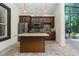 Outdoor kitchen featuring custom cabinets, granite countertops, and stainless steel appliances at 140 Seville Chase Dr, Winter Springs, FL 32708