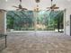 Enclosed outdoor space featuring brick flooring and a view of the backyard at 140 Seville Chase Dr, Winter Springs, FL 32708
