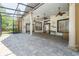 Expansive screened patio with stone flooring, ceiling fans, and elegant pillars perfect for outdoor living at 140 Seville Chase Dr, Winter Springs, FL 32708