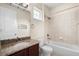 Bathroom featuring a granite vanity, tub and shower combo, and modern fixtures at 15208 Avenue Of The Arbors, Winter Garden, FL 34787