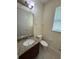 Half bathroom featuring a granite vanity, tile floors, and a modern mirror at 15208 Avenue Of The Arbors, Winter Garden, FL 34787