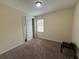 Sunny bedroom with neutral walls, a closet, and a window overlooking the yard at 15208 Avenue Of The Arbors, Winter Garden, FL 34787