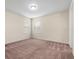 A bedroom with carpet flooring, ceiling light, and two windows at 15208 Avenue Of The Arbors, Winter Garden, FL 34787