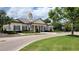 Exterior view of the clubhouse featuring architectural details and manicured landscaping at 15208 Avenue Of The Arbors, Winter Garden, FL 34787