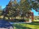 Entrance to the community featuring landscaping, a brick entrance, and well-maintained greenery at 15208 Avenue Of The Arbors, Winter Garden, FL 34787