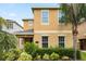Charming two-story home with a well-manicured lawn and lush tropical landscaping at 15208 Avenue Of The Arbors, Winter Garden, FL 34787