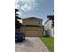 Exterior view of home featuring a two-car garage and brick-paved driveway at 15208 Avenue Of The Arbors, Winter Garden, FL 34787