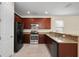 Features a kitchen with tile flooring, granite countertops, and stainless steel appliances at 15208 Avenue Of The Arbors, Winter Garden, FL 34787