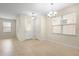 Bright room with tile floors and a chandelier adjacent to the entry door at 15208 Avenue Of The Arbors, Winter Garden, FL 34787