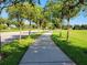 Inviting park pathway lined with lush greenery and trees, perfect for a peaceful walk or jog at 15208 Avenue Of The Arbors, Winter Garden, FL 34787
