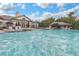 Community pool area with lounge chairs, umbrellas, and inviting water, perfect for relaxation at 15208 Avenue Of The Arbors, Winter Garden, FL 34787