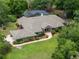 Aerial view of the home showcasing the pool, brick exterior, and landscaped grounds at 1550 Kevin Ln, Deland, FL 32724