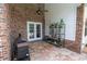 Cozy brick patio with grill and plants, perfect for outdoor entertaining and relaxation at 1550 Kevin Ln, Deland, FL 32724
