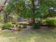 View of landscaped backyard with a screen enclosed lanai at 1550 Kevin Ln, Deland, FL 32724