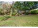 Landscaped backyard with a screen enclosed lanai at 1550 Kevin Ln, Deland, FL 32724