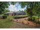 Landscaped backyard with a screen enclosed lanai at 1550 Kevin Ln, Deland, FL 32724