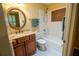Bathroom featuring granite countertop, vanity with framed mirror, and shower over tub at 1550 Kevin Ln, Deland, FL 32724