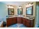 Primary bath featuring granite counters, dual sinks, custom vanity, and separate mirrors at 1550 Kevin Ln, Deland, FL 32724