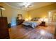 Main bedroom features hardwood floors, warm colors, and plenty of natural light at 1550 Kevin Ln, Deland, FL 32724