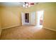 Spacious bedroom featuring neutral carpet, ceiling fan, and multiple entryways at 1550 Kevin Ln, Deland, FL 32724
