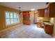 Charming dining area with decorative light fixture, window, built-in desk and lovely cabinetry at 1550 Kevin Ln, Deland, FL 32724
