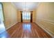Formal dining room with wood floors, decorative molding, and a chandelier at 1550 Kevin Ln, Deland, FL 32724