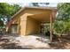 View of a large detached garage with carport and concrete driveway at 1550 Kevin Ln, Deland, FL 32724