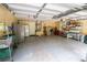 Spacious garage with storage shelves and concrete flooring offers ample space for vehicles and storage at 1550 Kevin Ln, Deland, FL 32724