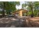 View of a large detached garage with carport and gravel driveway at 1550 Kevin Ln, Deland, FL 32724
