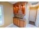 Hallway featuring built-in cabinets with glass doors and granite countertop at 1550 Kevin Ln, Deland, FL 32724