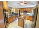 Spacious kitchen boasts stainless steel appliances, island, granite countertops, and tiled flooring at 1550 Kevin Ln, Deland, FL 32724