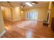 Bright living room boasts hardwood floors, a fireplace, and double doors to the outside at 1550 Kevin Ln, Deland, FL 32724