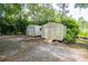 Two storage sheds located in a backyard with a gravel area and potted plants at 1550 Kevin Ln, Deland, FL 32724