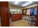 Large walk-in closet includes custom shelves, a bureau and abundant room for clothes and accessories at 1550 Kevin Ln, Deland, FL 32724