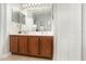 Bathroom with a double sink vanity and ample storage space behind the mirrored cabinets at 15606 Montesino Dr, Orlando, FL 32828