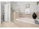 Relaxing bathroom with soaking tub, glass-enclosed shower, and neutral tile work at 15606 Montesino Dr, Orlando, FL 32828