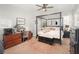 Bedroom featuring a canopy bed, a work space, and neutral color tones throughout the room at 15606 Montesino Dr, Orlando, FL 32828