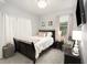 Comfortable bedroom featuring a dark wood bed frame, soft lighting, and light colored walls at 15606 Montesino Dr, Orlando, FL 32828