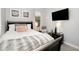 Comfortable bedroom with a sleek bed frame, soft bedding, and modern media setup for relaxation and entertainment at 15606 Montesino Dr, Orlando, FL 32828