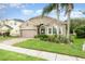 Inviting one-story home with lush landscaping, mature palm trees, and a well-maintained lawn at 15606 Montesino Dr, Orlando, FL 32828
