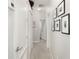 Bright hallway with neutral carpet, white walls, decorative trim, and modern lighting at 15606 Montesino Dr, Orlando, FL 32828