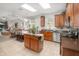 Bright kitchen with eat-in table, wood cabinets, stainless appliances, and an open flow to the living room at 15606 Montesino Dr, Orlando, FL 32828