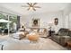 Comfortable living room offers neutral decor, plush furniture, ceiling fan, and access to outdoor living area at 15606 Montesino Dr, Orlando, FL 32828