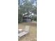 The backyard has a spacious porch, lawn area, and is shaded by a mature oak tree at 1717 Se 190Th Ave, Silver Springs, FL 34488