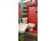 Small, colorful bathroom with unique storage shelves and red accents at 1717 Se 190Th Ave, Silver Springs, FL 34488