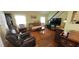 Spacious living room with hardwood floors, comfortable seating, and natural light at 1717 Se 190Th Ave, Silver Springs, FL 34488